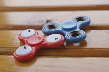 Two Fidget Spinner Lying On Wood Table