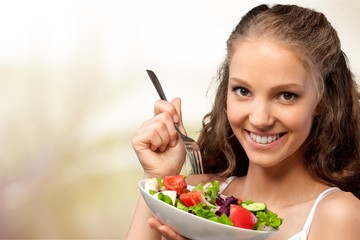 Young woman with bowl of salad