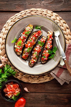 Baked eggplants with tomatoes, onion and garlic