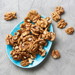 Walnut kernels on gray background.