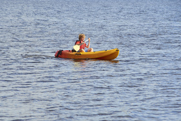 Active happy child. Teenage school boy having fun enjoying adventurous experience kayaking on the...