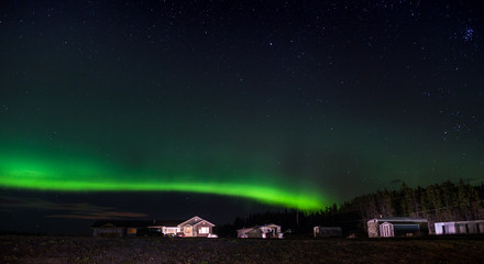 Northern Lights with a isolated house in the foreground