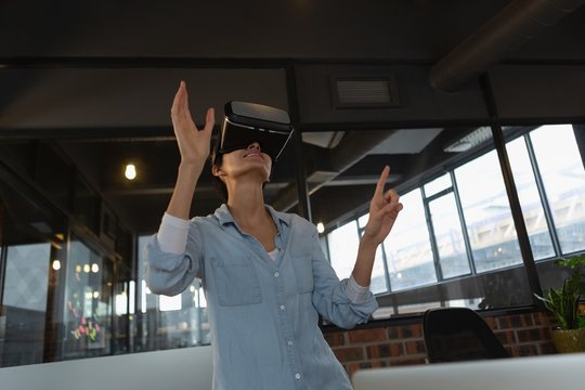 Businesswoman experiencing virtual reality headset