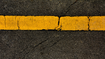 Yellow paint line on black asphalt. space transportation background