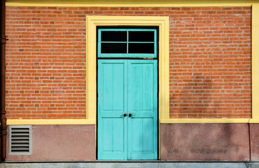 antique blue wood door at red brick building