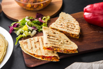 Mexican quesadilla with chicken, tomato, corn, onion, cheese