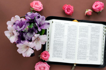 Bible and flowers on white background. Concept for faith, spirituality and religion.