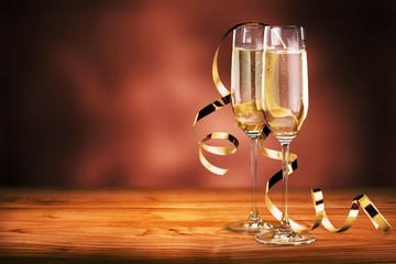 Glasses of champagne with curly ribbon on