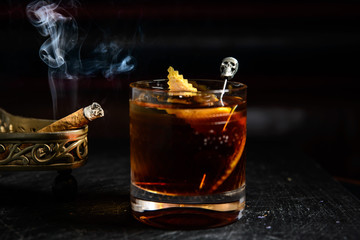 whiskey with ice and rye in a glass on a dark background