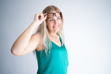 Cheerful blonde woman recovering sight with laser eye surgery and stop wearing glasses. Beautiful...