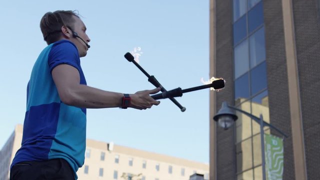 Close up slow motion juggler with fire pins