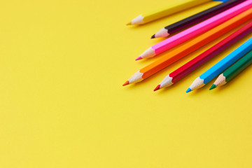  Colored pencils on a yellow background