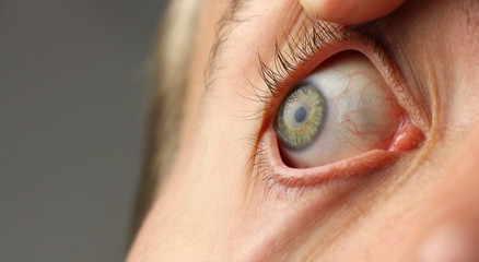 wide open human eye, pupil is looking to the side, closeup macro, copy space