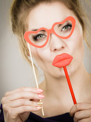 woman holds carnival accessories on stick