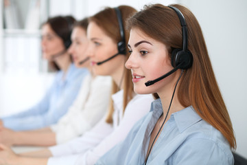 Call center operator.Young beautiful brunette woman in headset. Business concept