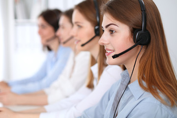 Call center. Beautiful cheerful smiling operator consulting clients with headset. Business concept of customer service