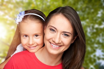 Fototapeta premium Happy smiling family with daughter over green