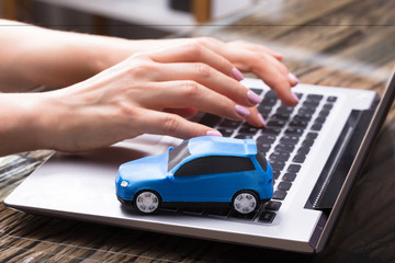 Small Blue Car On Laptop Keypad