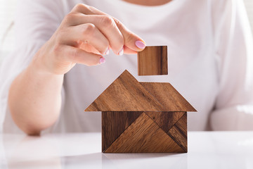 Woman Building House With Wooden Tangram Puzzle