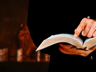 Man hands holding open book on black