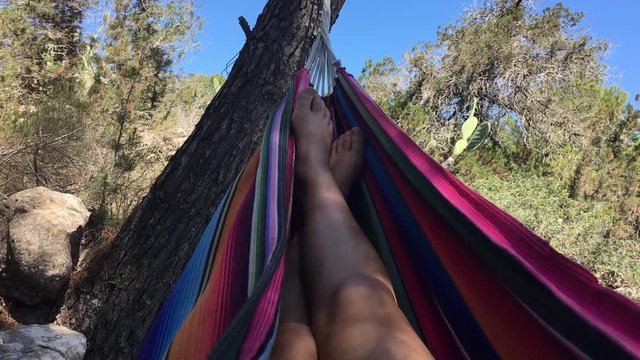 Girl relaxing in a hammock swinging