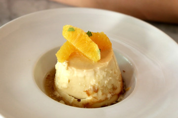 Traditional Catalan dessert made with egg cream and orange. Selective focus.