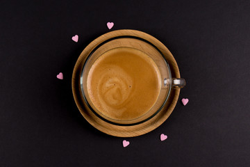 Coffee cup from above centered with small hearts around on black background, I Love Coffee Concept.