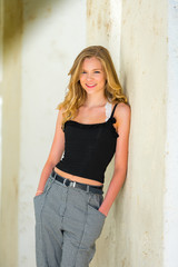 Blond Teen Girl Leaning Against Wall