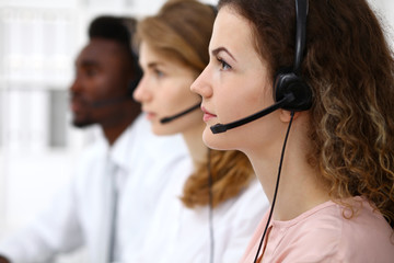 Call center operator.Young beautiful  brunette woman in headset. Business concept