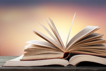 Big opened book with sparkles on background