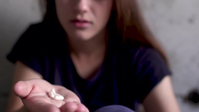Young girl swallowing pills
