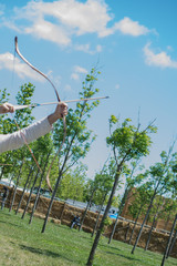 Archer in traditional clothes shooting an arrow