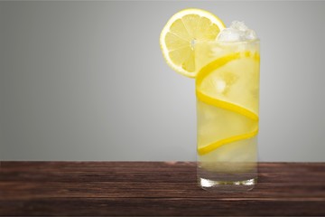 Lemonade with fresh lemon on desk