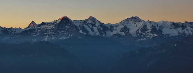 Famous mountains Eiger, Monch and Jungfrau at sunrise.
