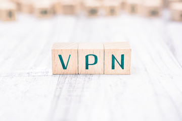 The Word VPN Formed By Wooden Blocks On A White Table