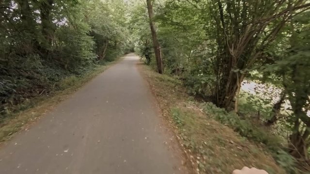 Riding a bike through the woods in slow motion