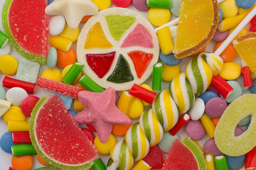 Multicolored candy and lollipops. background