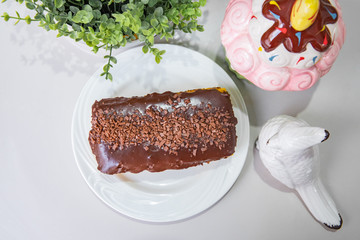 Carrot cake with chocolate - With plate and white background on a decorated table - Top view