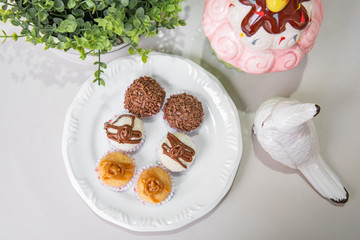 Brigadeiro Traditional brazilian sweet - brigadier - With plate and white background on a decorated table - Top view