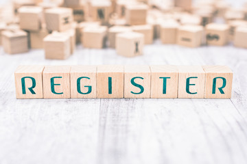 The Word Register Formed By Wooden Blocks On A White Table, Reminder Concept