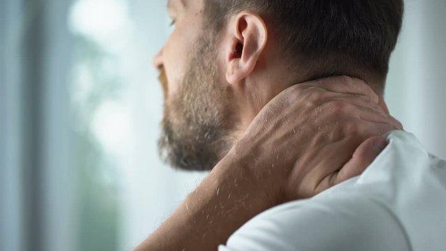 Middle-aged man feeling neck pain in morning, uncomfortable mattress, healthcare