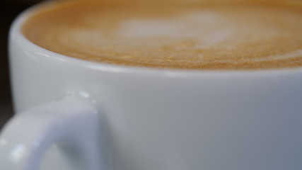 close up of latte cup and foam with depth of field. macro shot