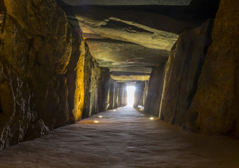 Obraz premium Sun rays entering at Dolmen de Soto chamber. Sun-aligned megalithic monument, Trigueros,Spain