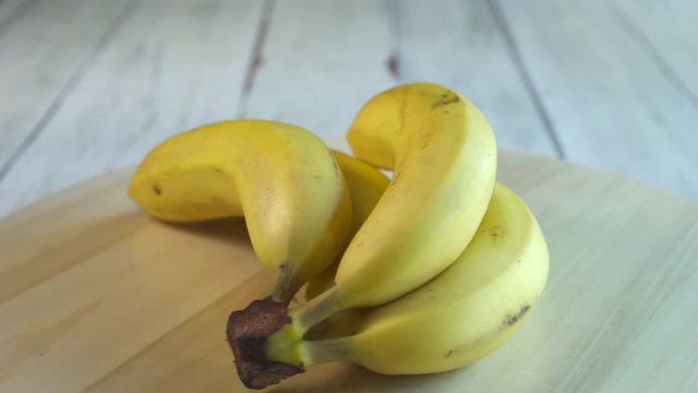 Fresh bananas rotate on the table. Bananas close up shot