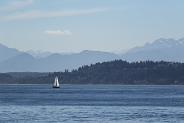 Sailing in puget sound with the olympic mountains behind