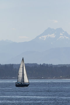 Sailing in the puget sound with the olympic mountains behind