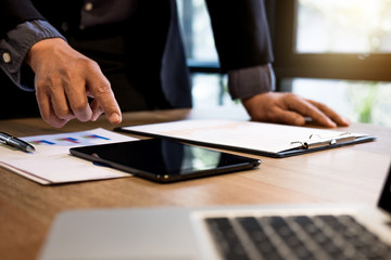 Professional business woman working, Doing finance on digital tablet, document graph and analysis business strategy to development profit