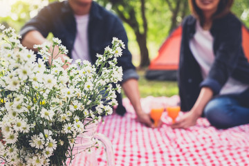 Couple in love drink a orange juice and fruits on summer picnic, leisure, holidays, eating, people...