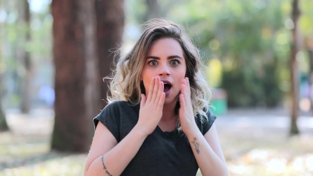 Girl turns around with a shock expression look and then laughs