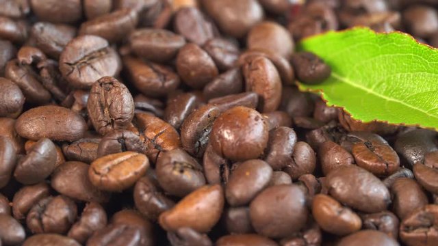 Roasted coffee beans heap. Macro sliding shot.
